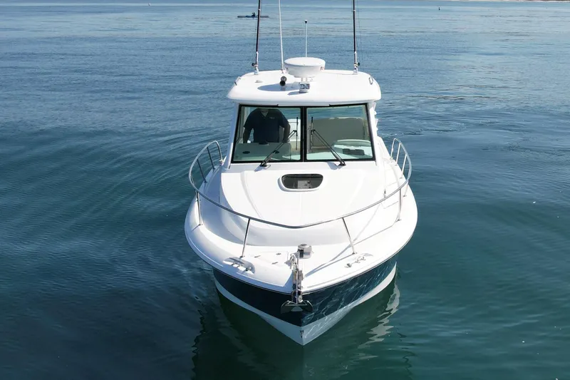 Slide: The Image of 2018 Boston Whaler 315 Conquest boat on calm water, front view. - 5
