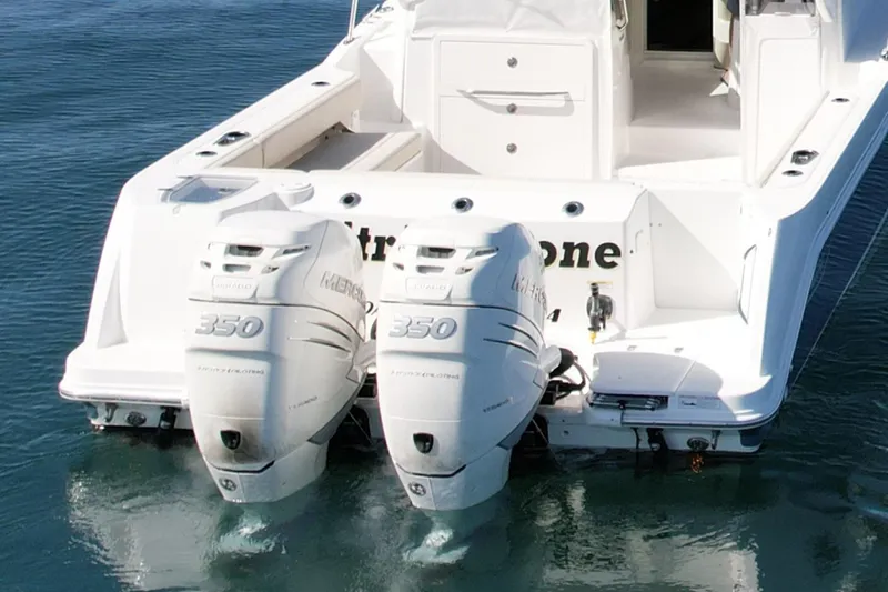 Slide: The Image of 2018 Boston Whaler 315 Conquest with twin 350 horsepower engines on calm water. - 8