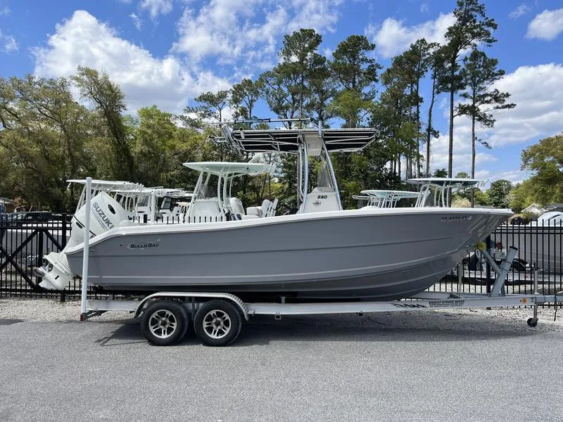 Slide: The Image of 2020 Bulls Bay 230 Center Console boat on trailer, parked outdoors under blue sky. - 1