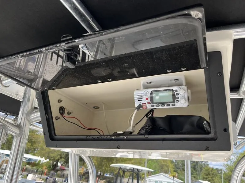 Slide: The Image of 2020 Bulls Bay 230 Center Console electronics compartment with radio and wiring. - 13