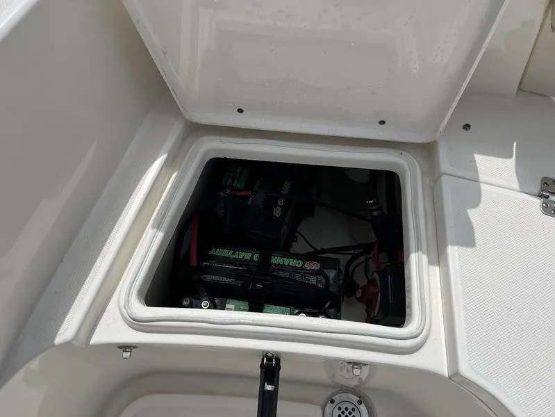 Slide: The Image of 2020 Bulls Bay 230 Center Console boat battery compartment open. - 18