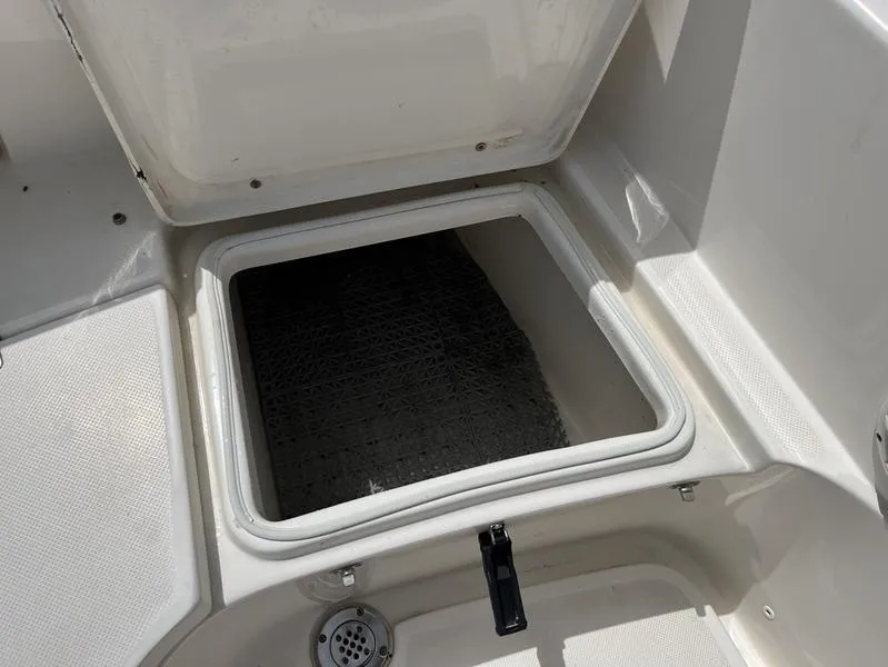Slide: The Image of 2020 Bulls Bay 230 Center Console storage compartment with open hatch. - 20