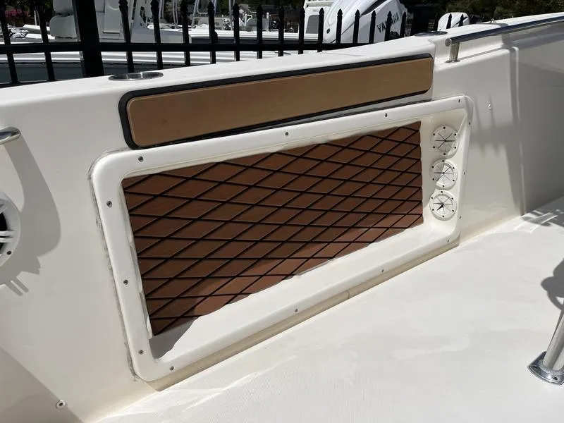 Slide: The Image of 2020 Bulls Bay 230 Center Console boat interior with brown paneling and white accents. - 22