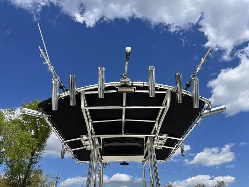 Slide: The Image of Bulls Bay 230 Center Console 2020 boat with rod holders against a blue sky. - 24