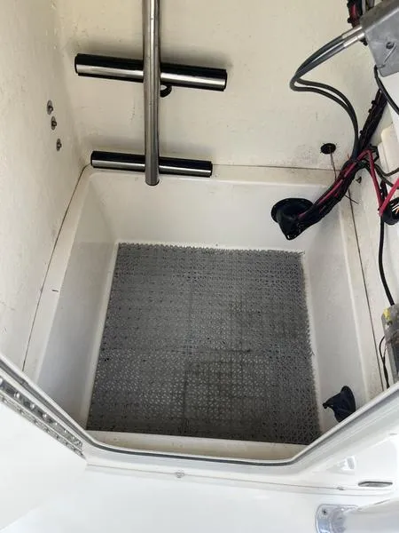 Slide: The Image of 2020 Bulls Bay 230 Center Console storage compartment with wiring and metal bars. - 26