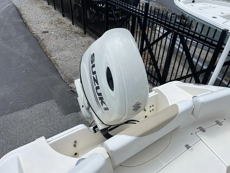 Slide: The Image of 2020 Bulls Bay 230 Center Console boat with Suzuki outboard motor, docked near a fence. - 27