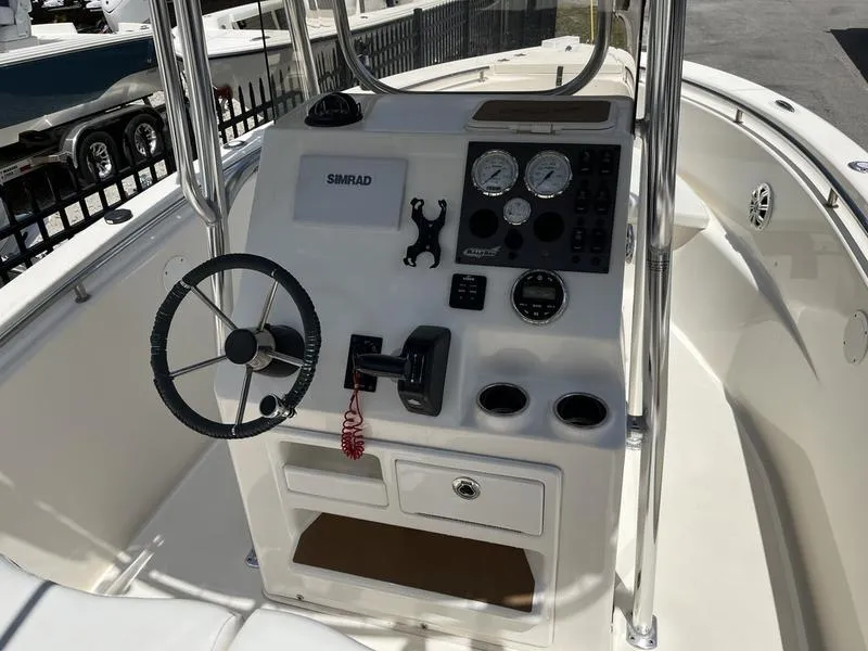 Slide: The Image of 2020 Bulls Bay 230 Center Console boat dashboard with steering wheel and controls. - 9