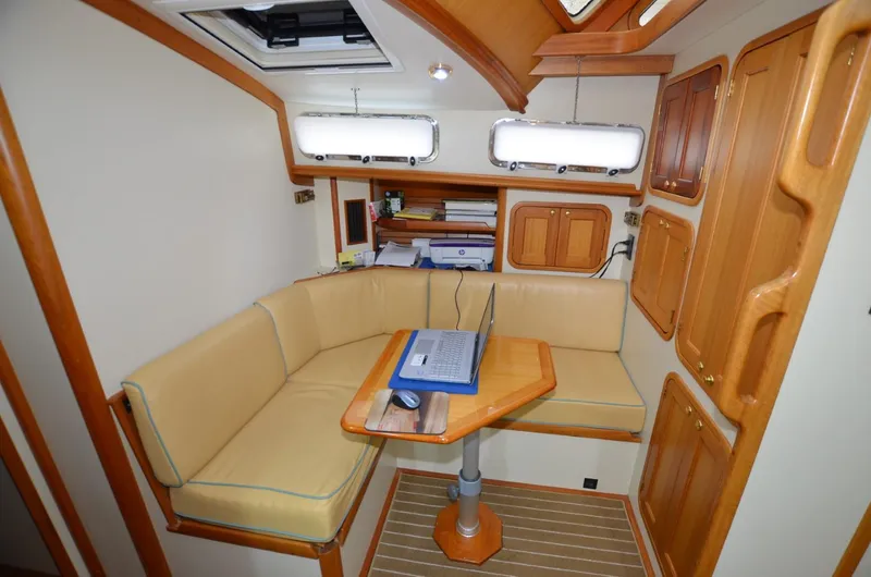 Slide: The Image of 2006 Legacy Yachts Sedan interior with cozy seating and wooden accents. - 12