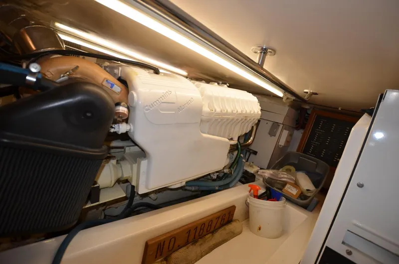 Slide: The Image of Engine room of 2006 Legacy Yachts Sedan, featuring a well-maintained engine and storage area. - 16