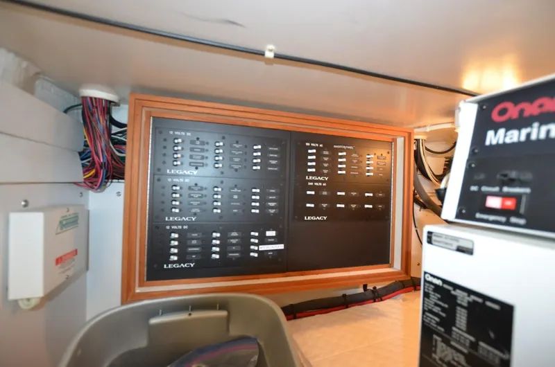 Slide: The Image of Electrical panel inside 2006 Legacy Yachts Sedan, showcasing wiring and control systems. - 19