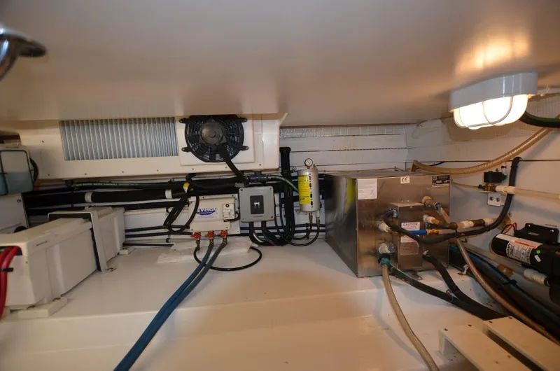 Slide: The Image of Engine room of 2006 Legacy Yachts Sedan, featuring wiring and mechanical components. - 20