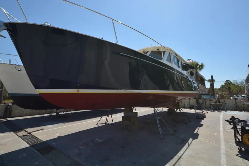 Slide: The Image of 2006 Legacy Yachts Sedan on dry dock, showcasing sleek design and craftsmanship. - 23