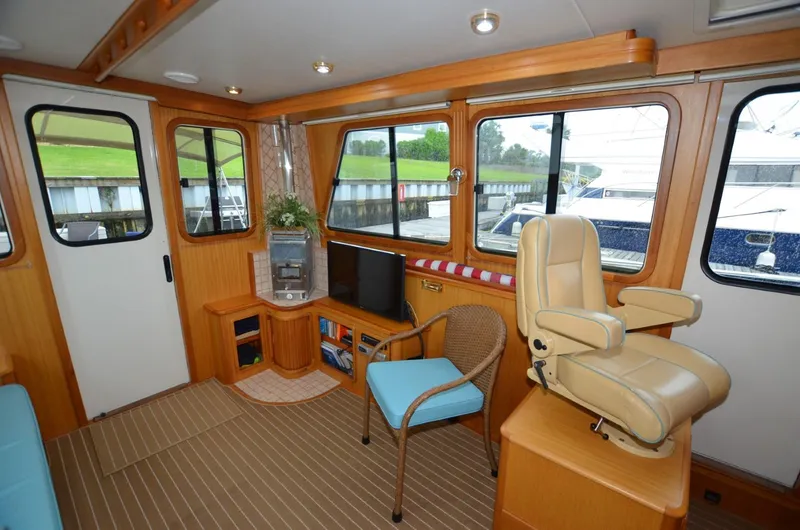 Slide: The Image of 2006 Legacy Yachts Sedan interior with seating, windows, and wooden accents. - 4