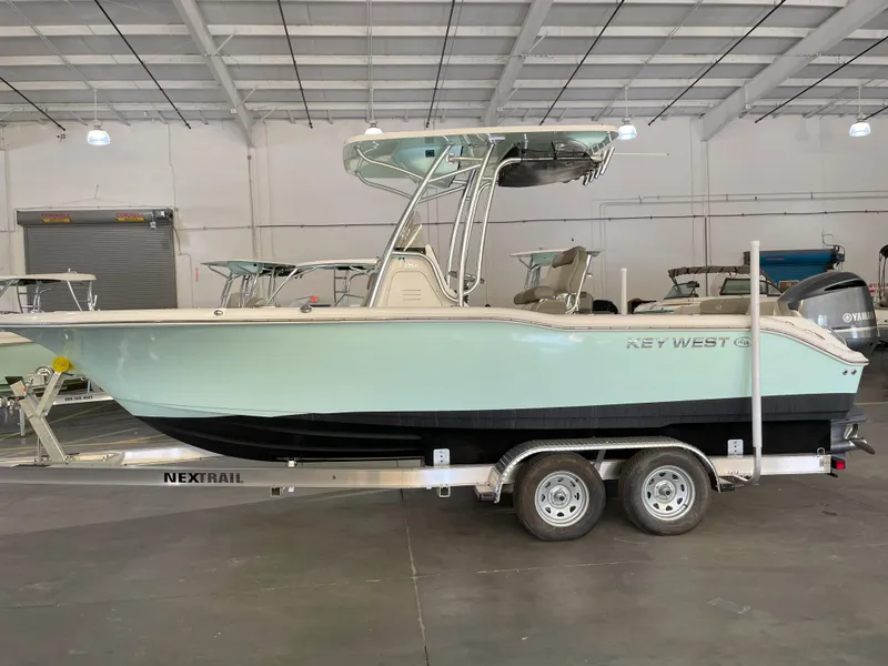 The Image of 2024 Key West 239 FS boat on trailer in indoor showroom. - 0