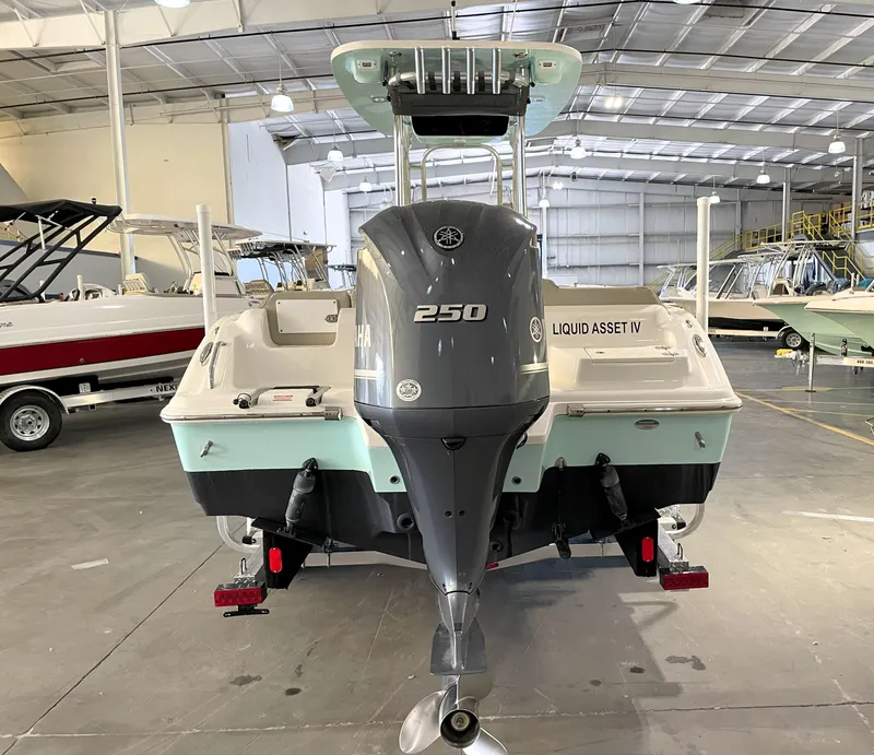 Slide: The Image of 2024 Key West 239 FS boat with Yamaha 250 engine in a showroom. - 11