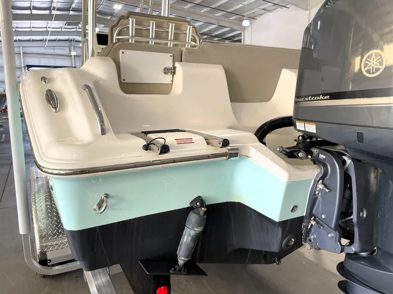 Slide: The Image of 2024 Key West 239 FS boat with outboard motor in a covered storage area. - 12