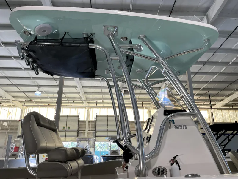 Slide: The Image of 2024 Key West 239 FS boat interior with T-top and seating in a showroom. - 19