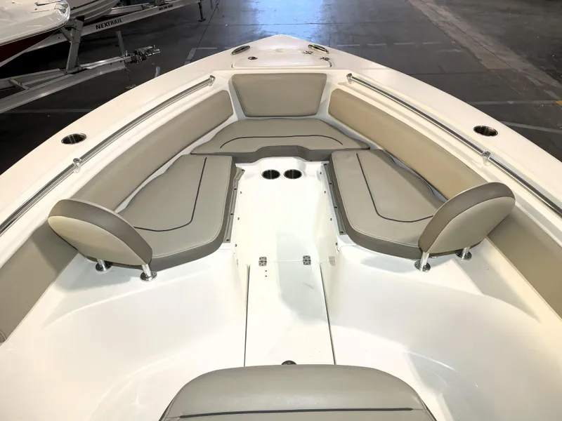 Slide: The Image of 2024 Key West 239 FS boat interior with cushioned seating and cup holders. - 20