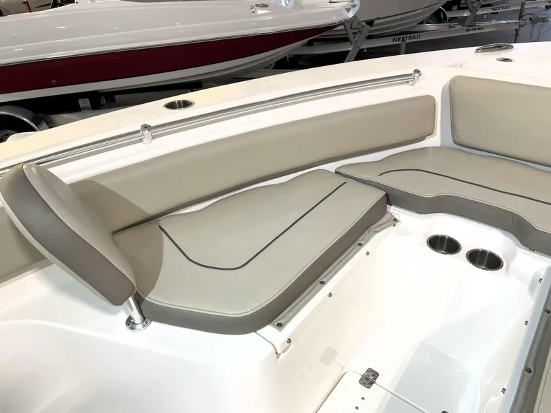 Slide: The Image of 2024 Key West 239 FS boat interior with beige seating and cup holders. - 21
