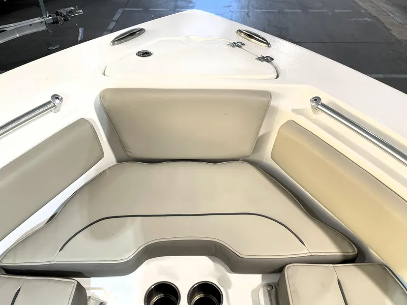 Slide: The Image of 2024 Key West 239 FS boat interior with cushioned seating and stainless steel fittings. - 23