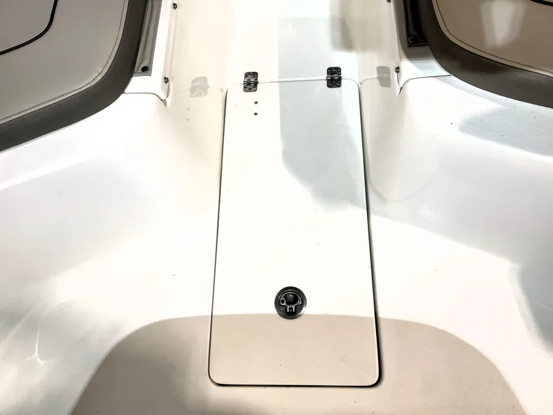 Slide: The Image of 2024 Key West 239 FS boat interior, featuring a sleek white deck with storage compartment. - 24