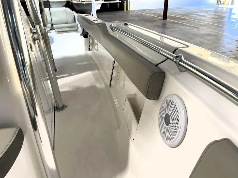 Slide: The Image of 2024 Key West 239 FS boat interior with cushioned seating and speaker. - 28