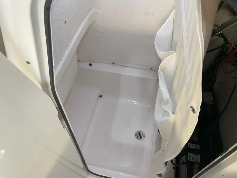 Slide: The Image of 2024 Key West 239 FS boat storage compartment with drainage and mesh pocket. - 31