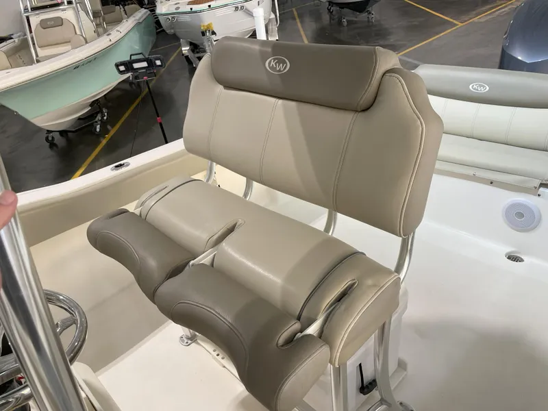 Slide: The Image of 2024 Key West 239 FS boat seat with beige upholstery in a showroom setting. - 33