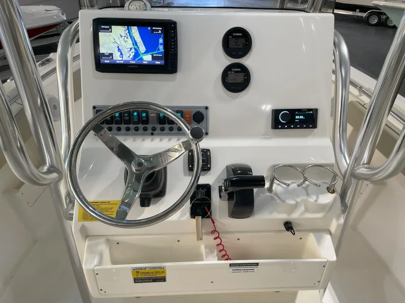 Slide: The Image of 2024 Key West 239 FS boat dashboard with GPS, steering wheel, and controls. - 34