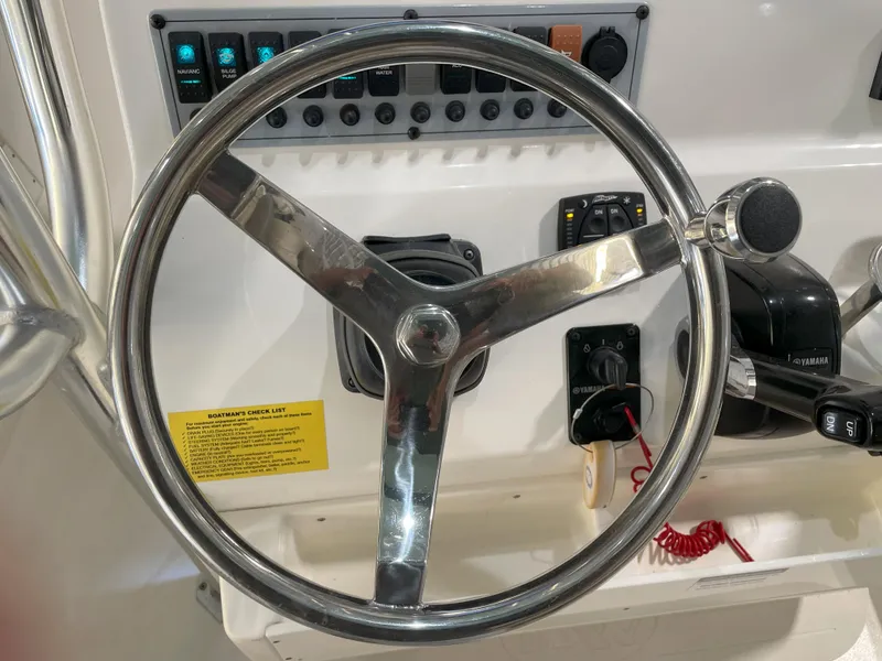 Slide: The Image of Steering wheel and controls of 2024 Key West 239 FS boat cockpit. - 38