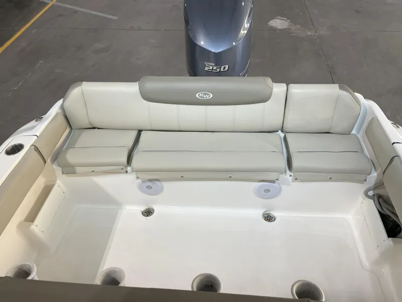 Slide: The Image of 2024 Key West 239 FS boat interior with cushioned seating and Yamaha 250 engine. - 40