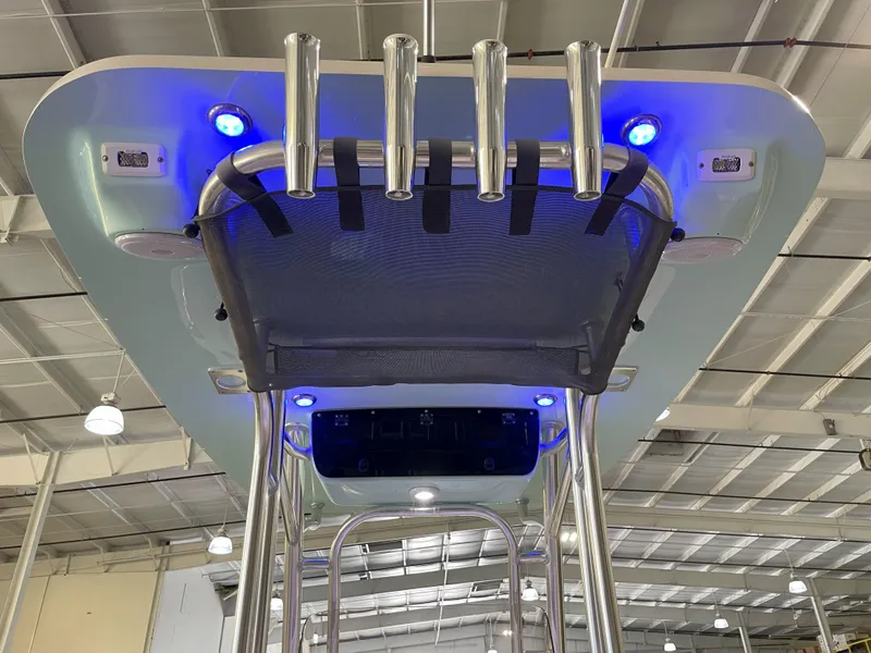 Slide: The Image of 2024 Key West 239 FS boat with blue LED lights and rod holders in a showroom. - 44