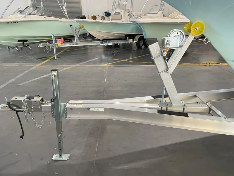 Slide: The Image of 2024 Key West 239 FS boat trailer in a showroom setting. - 49