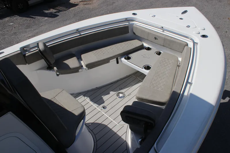 Slide: The Image of 2023 Sea Pro 239 Deep V CC boat interior with cushioned seating and cup holders. - 11