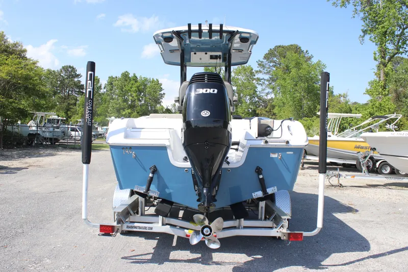 Slide: The Image of 2023 Sea Pro 239 Deep V CC boat with powerful 300 HP engine, parked outdoors. - 3