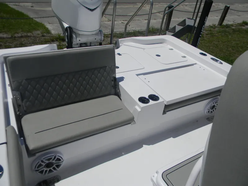 Slide: The Image of 2025 Sportsman Masters 267 Bay Boat interior with cushioned seating and storage compartments. - 6