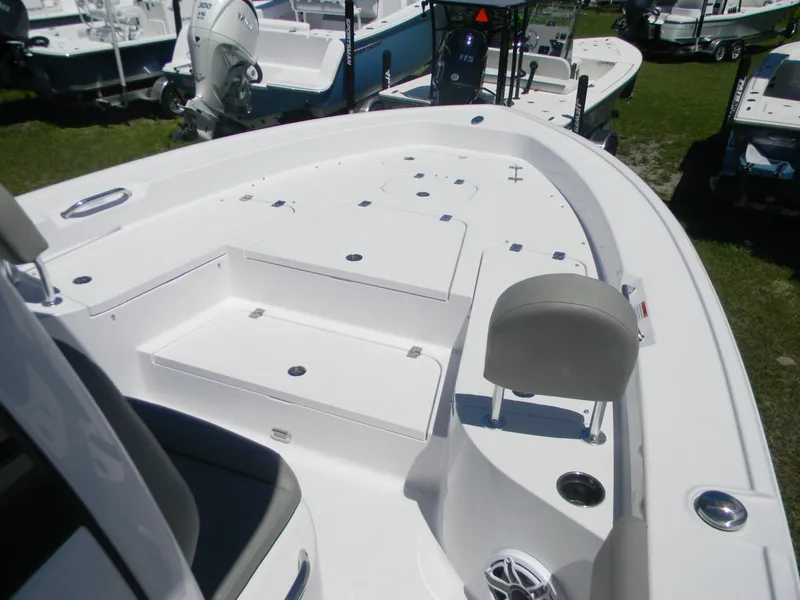Slide: The Image of 2025 Sportsman Masters 267 Bay Boat, white deck, seating, and storage compartments. - 8