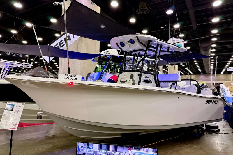 Slide: The Image of 2025 Sea Pro 225FLX Sandbar boat displayed indoors with trailer included. - 16