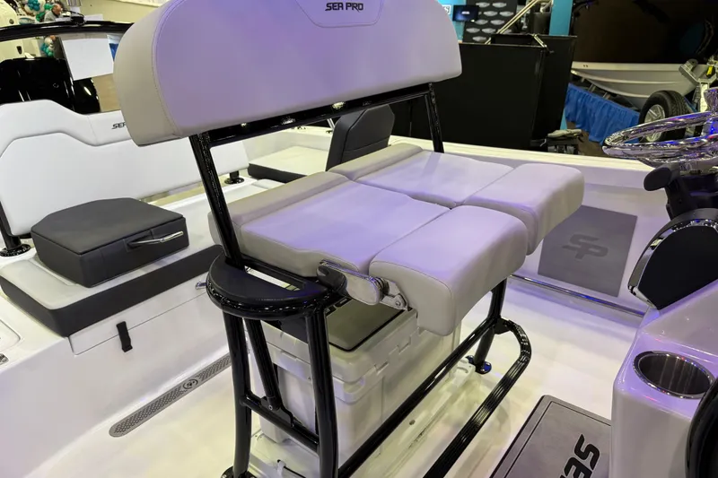 Slide: The Image of 2025 Sea Pro 225FLX Sandbar boat interior with cushioned seating and steering wheel. - 24