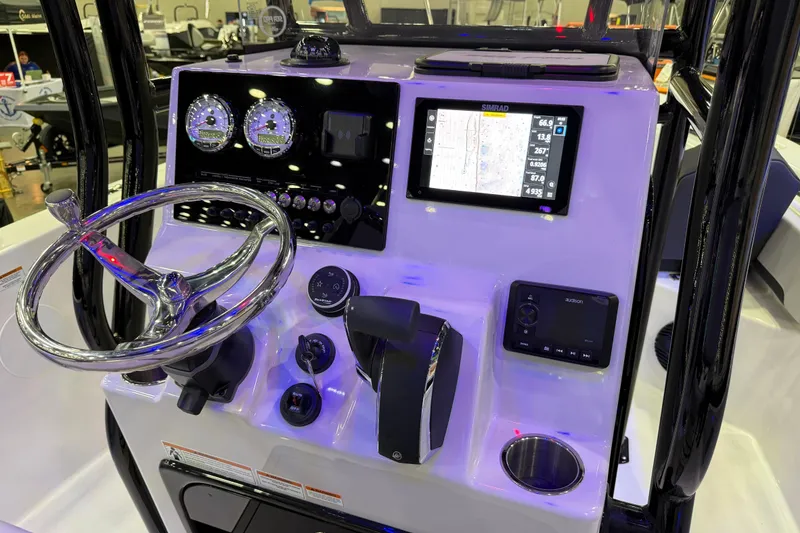 Slide: The Image of 2025 Sea Pro 225FLX Sandbar boat dashboard with steering wheel and navigation display. - 25