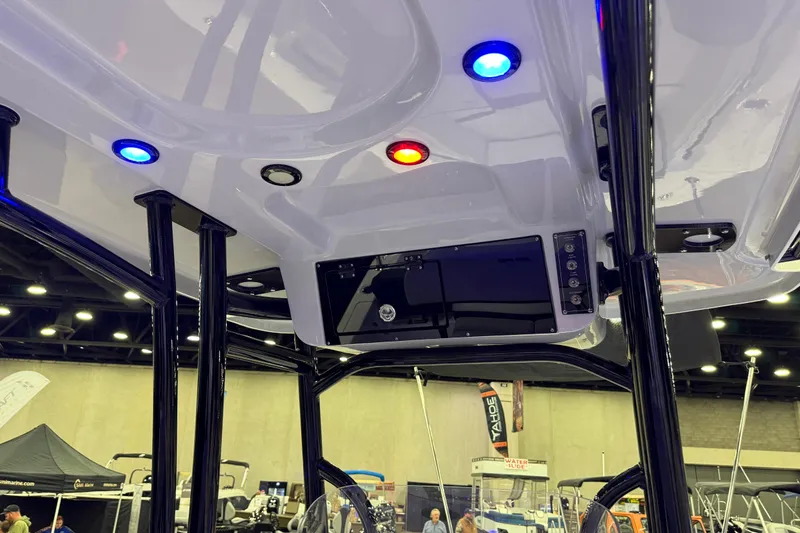 Slide: The Image of Interior view of 2025 Sea Pro 225FLX Sandbar boat with colorful LED lights. - 26
