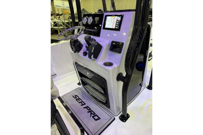 Slide: The Image of 2025 Sea Pro 225FLX Sandbar boat console with steering wheel and navigation display. - 29