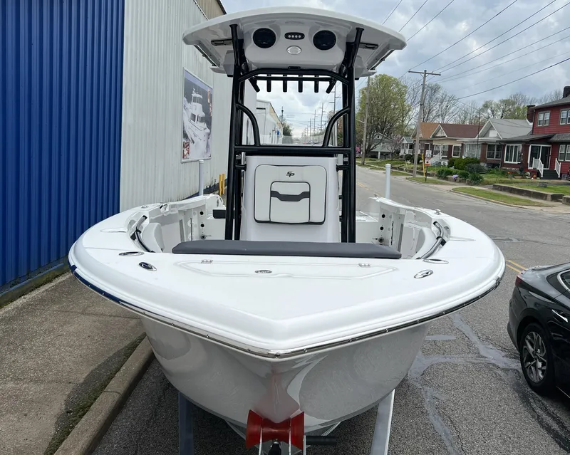 Slide: The Image of 2025 Sea Pro 225 Sandbar boat, white exterior, parked on urban street. - 4