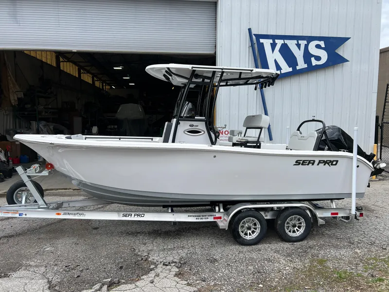 Slide: The Image of 2025 Sea Pro 225 Sandbar boat on trailer outside KYS building. - 8