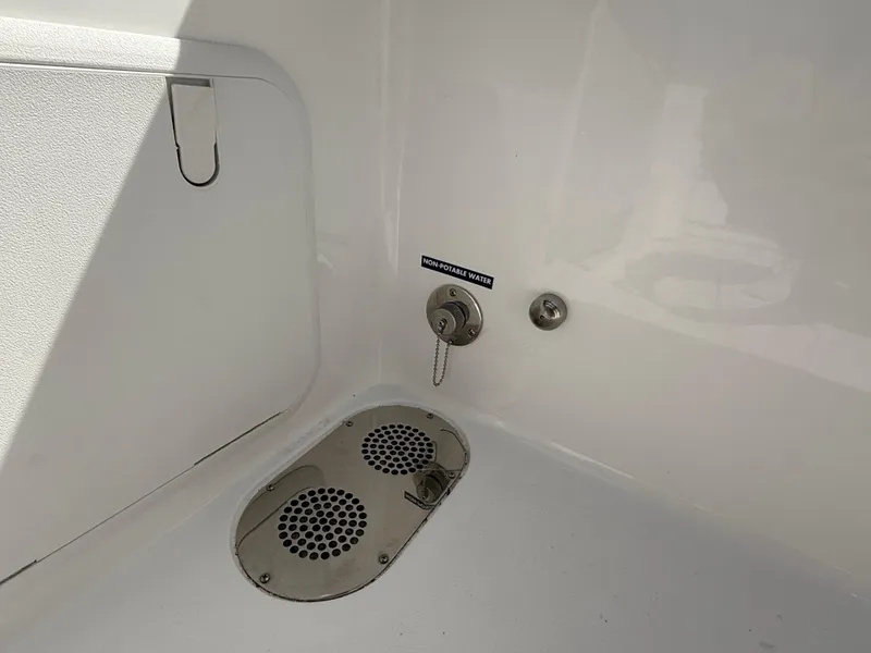 Slide: The Image of 2025 NauticStar 292 Legacy boat interior detail with drainage and utility features. - 12