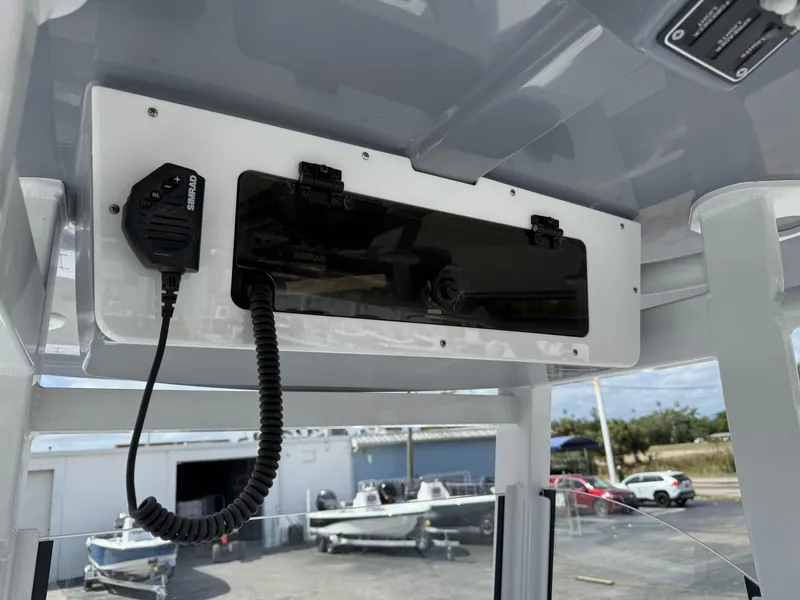 Slide: The Image of 2025 NauticStar 292 Legacy boat console with radio and microphone. - 18