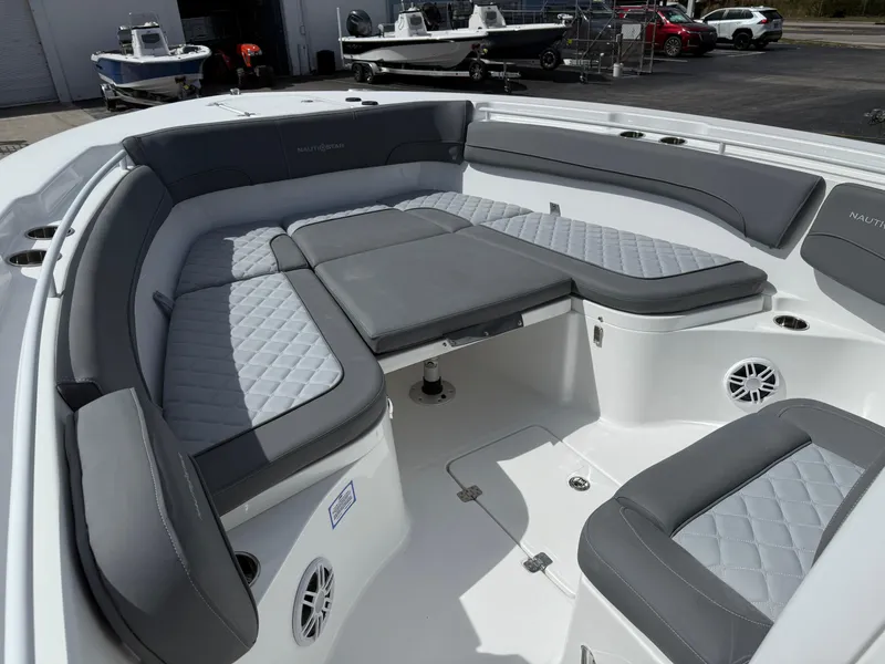Slide: The Image of 2025 NauticStar 292 Legacy boat interior with gray cushioned seating and modern design. - 19