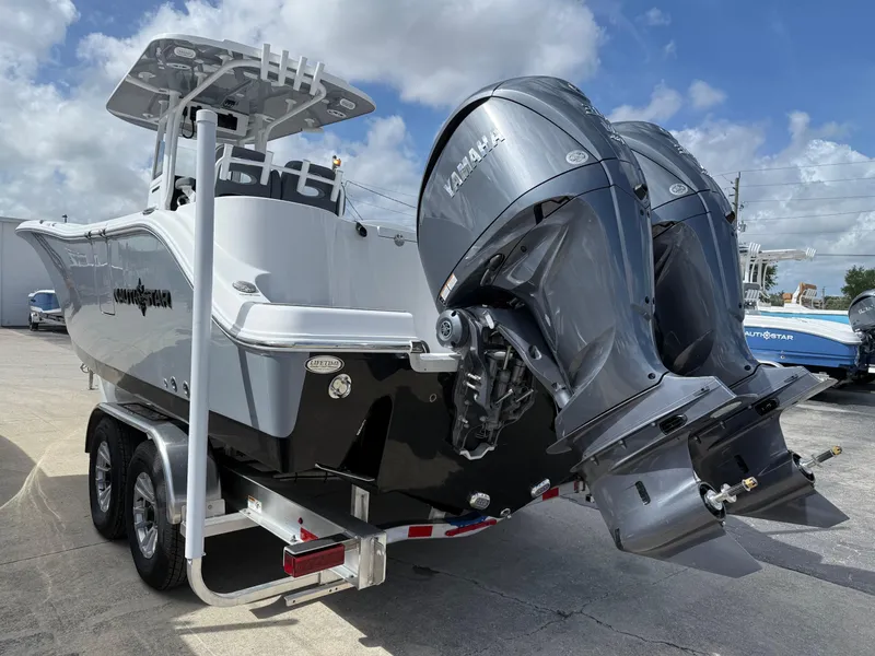 Slide: The Image of 2025 NauticStar 292 Legacy boat with dual Yamaha outboard engines on a trailer. - 4