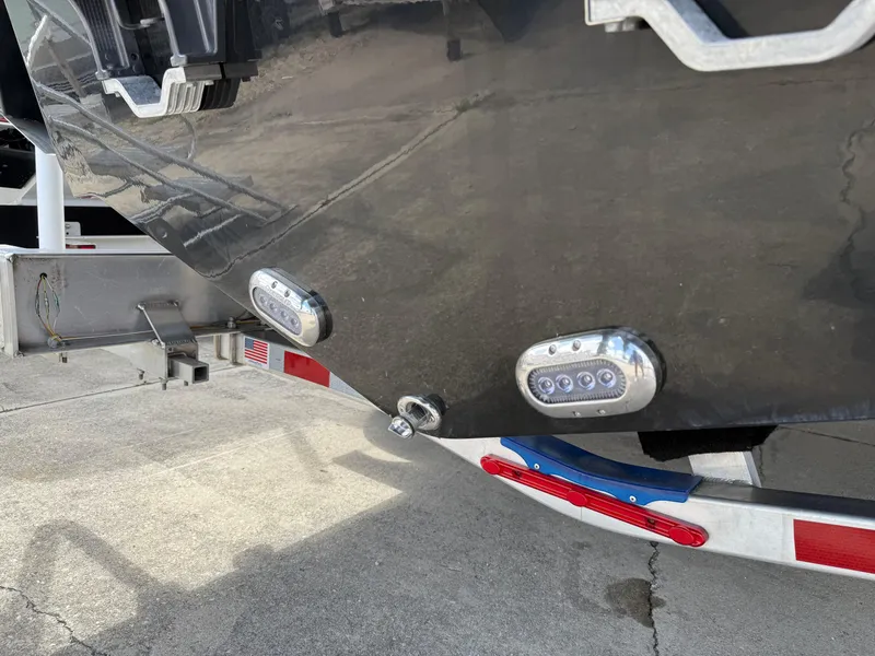 Slide: The Image of 2025 NauticStar 292 Legacy boat on trailer, featuring underwater LED lights. - 6