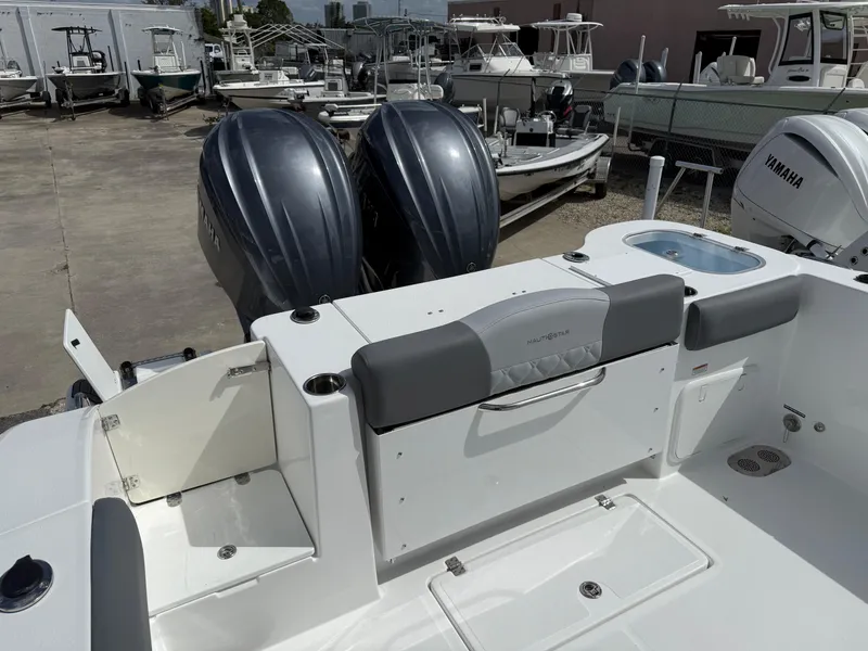 Slide: The Image of 2025 NauticStar 292 Legacy boat with dual engines, docked in a marina. - 8